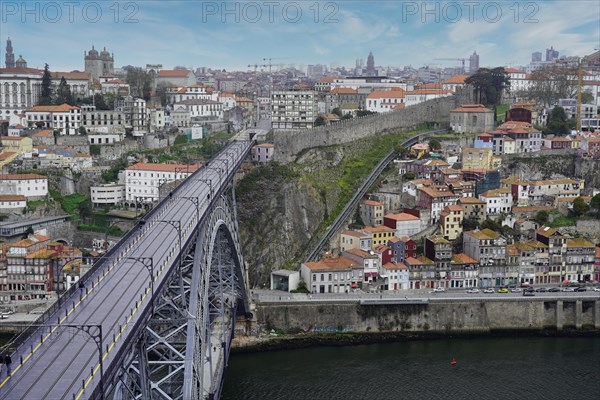 View of the Dom Luis I bridge over Douro River and terracota rooftops