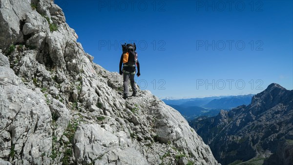 Tourist with equipment on the via ferrata trail in the alps. Zugspitze massif