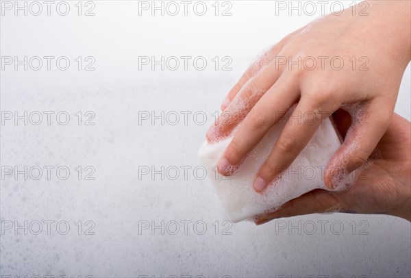 Hand washing and soap foam on a foamy background