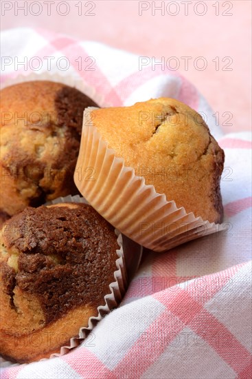 Chocolate muffins in kitchen towel