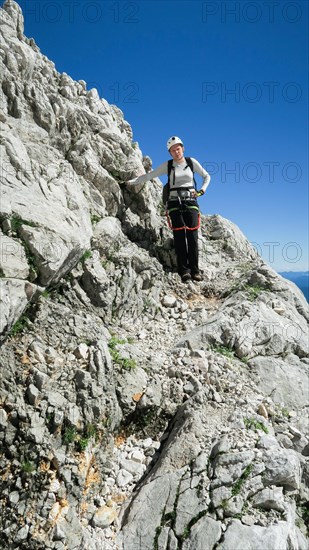 Womans crossing the via ferrata trail in the alps. Zugspitze massif