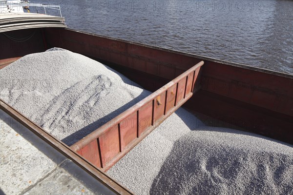 Barge in port loaded with bulk cargo