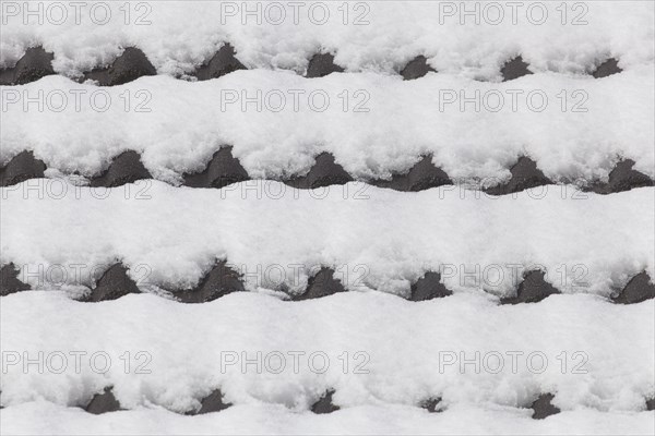 Snowy roof tiles on a roof in winter