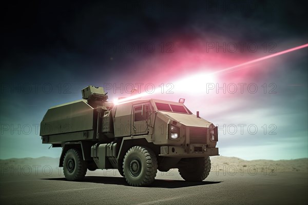 Military vehicle fires laser gun at a target