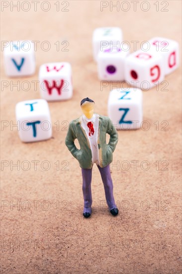 Figurine standing in front of the colorful alphabet letter cubes