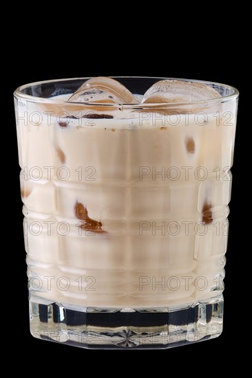 Cocktail white russian in facetted glass on black background