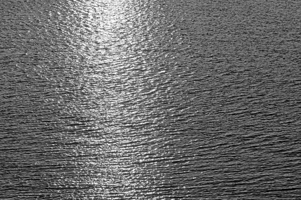 Sea surface with small waves and light reflections