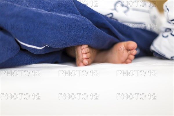 Childrens feet in bed