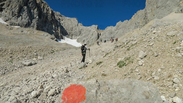 Tourist with equipment on a mountain trail in the Alps. Zugspitze massif