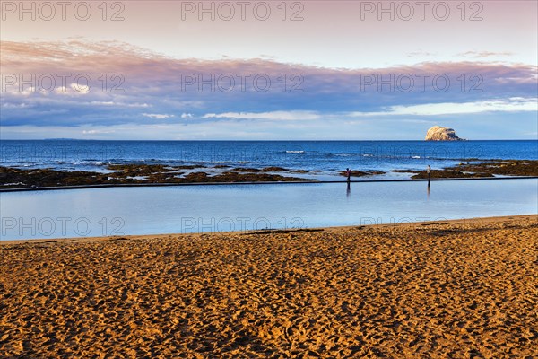 Coastline with beach and volcanic rock Bass Rock on the horizon