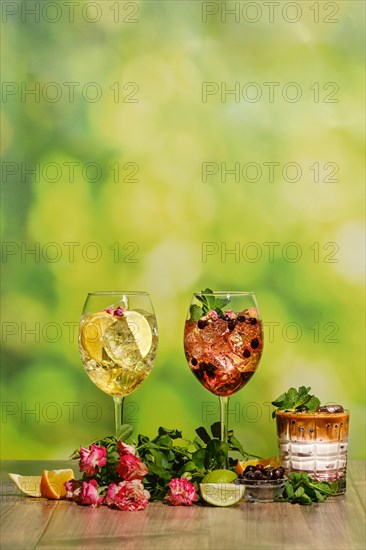 Set of cold sangria in a wine glass and iced coffee summer drinks on wooden table with ingredients