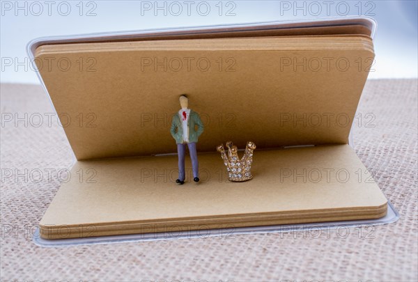 Figurine notebook and model crown