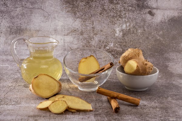 Jar of fresh ginger tea with lemon and cinnamon