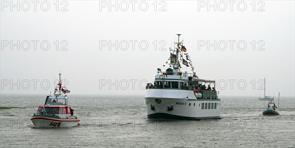 Lifeboat Herman Onken of the DGzRS and passenger ship Wege zwei enter the harbour of Fedderwardersiel County Wesermarsch Germany Europe