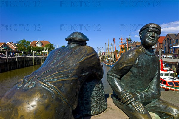 Two bronze statues at the harbour head of Neuharlingersiel