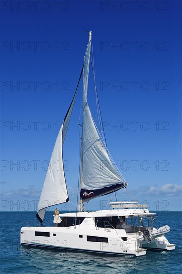 Woman enjoying the ride on a sailing catamaran