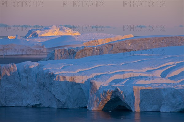 Icebergs at sunset in the Kangia icefjord