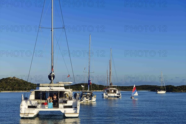 Sailboats and catamarans anchor off Warderick Wells