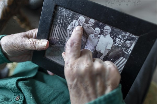 Old hands with a family photo.