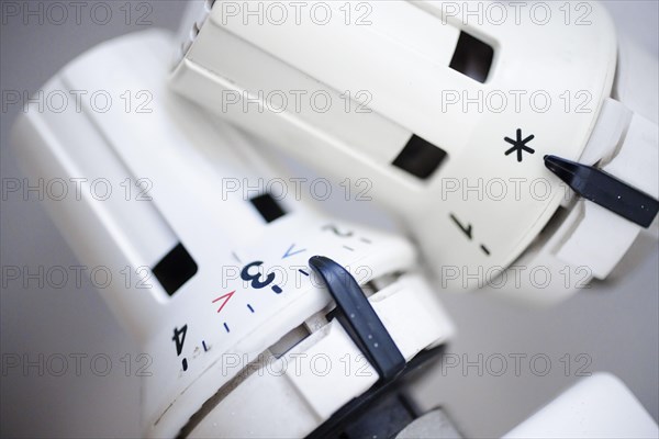 Symbolic photo on the subject of increased heating costs. Thermostats of radiators. Berlin