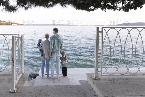 Family standing by the sea