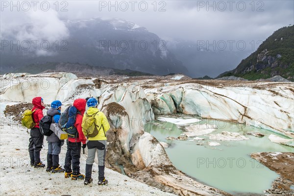 Hikers on the Exploradores glacier in the San Valentin massif