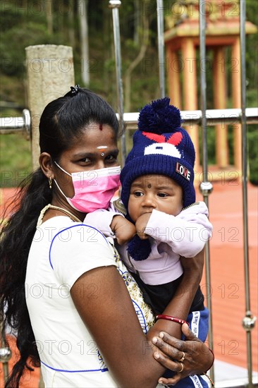 Mother with mouth guard and child with playboy cap