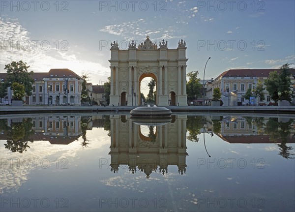 Reflection Brandenburg Gate in water basin