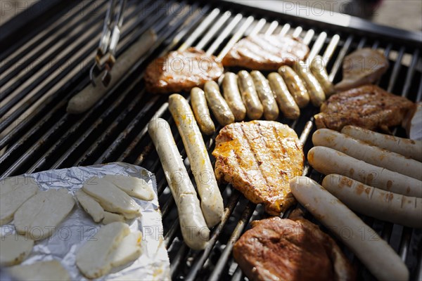 Selection of vegan and vegetarian sausages on a grill.