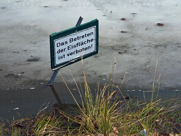 Warning sign in a pond