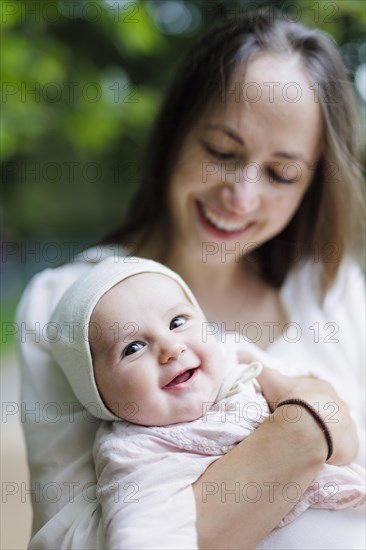 Mother beaming at her baby