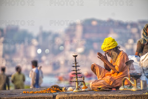 Spiritual morning prayer at the holy river Ganges in Varanasi