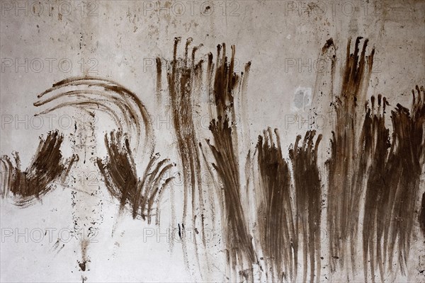 Handprints are seen on a wall of a house in Schuld