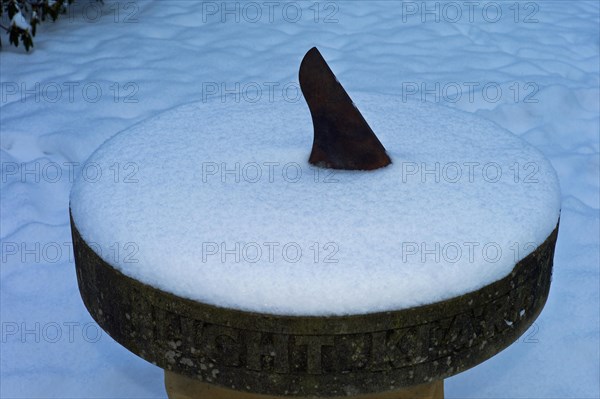 Snow-covered sundial