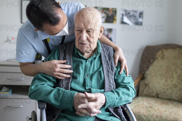 Geriatric nurse talking to a resident in a nursing home