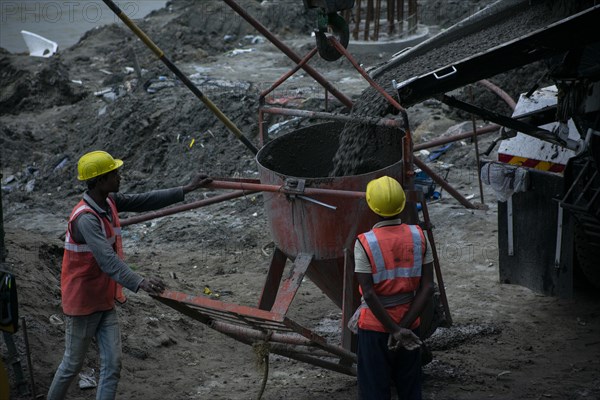 Construction workers busy build pillars of a bridge in the banks of Brahmaputra river on April 3