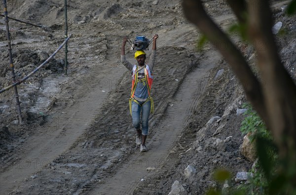 Construction workers busy build pillars of a bridge in the banks of Brahmaputra river on April 3