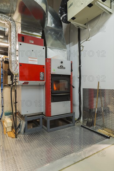 Napoleon series 9500 natural gas and hydrid 200 wood burning heating systems with ducts in mechanical room with steel plate flooring inside home