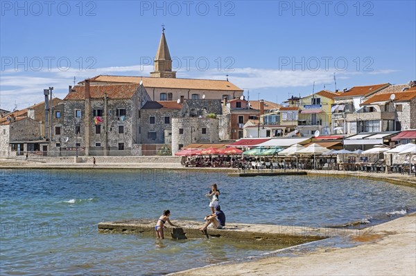 Terraces of restaurants along the waterfront in the town Umag