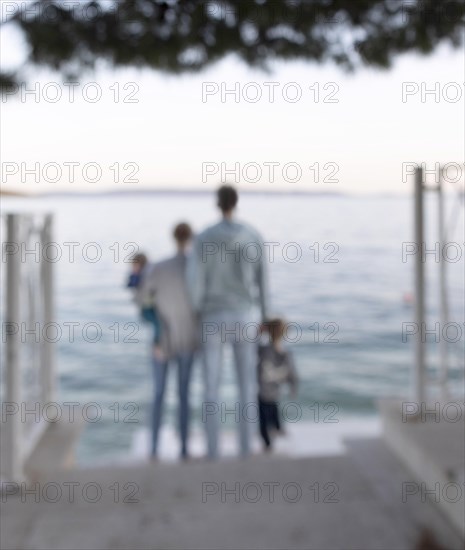 Family standing by the sea