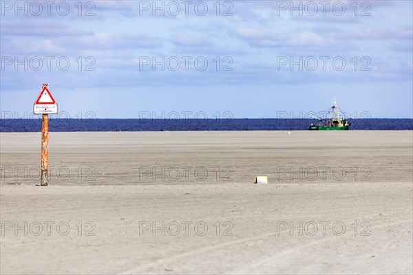 Crab cutter on the North Sea coast and sandy beach at low tide