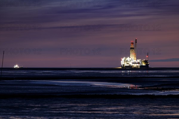 Germanys only oil rig Mittelplate at night and low tide