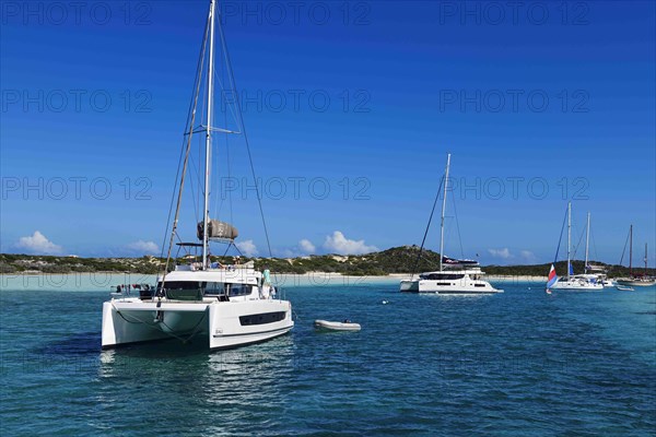 Sailboats and catamarans anchor off Warderick Wells