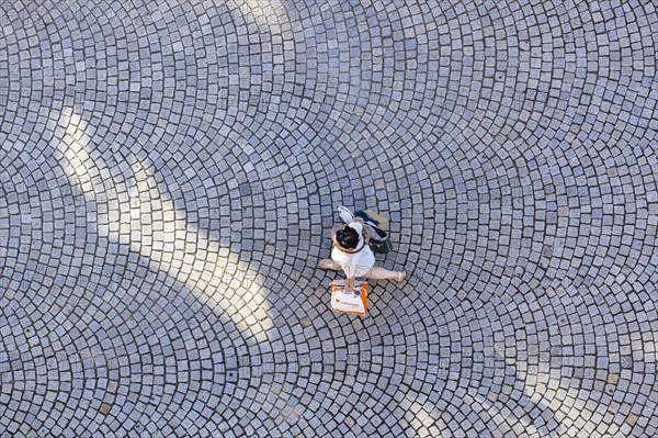 A woman with a shopping bag from a birds eye view