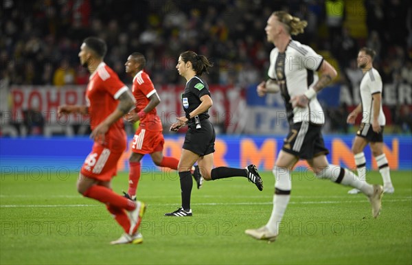 Referee Ref Maria Sole Caputi Italy between football players from Peru and Germany