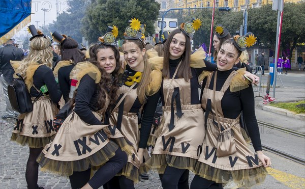 Four smiling girls masked in clock dresses at the carnival in the city of Rijeka