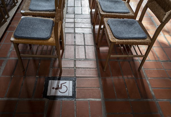 Wheelchair symbol next to a row of chairs