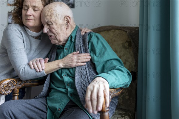 Old man in nursing home is comforted