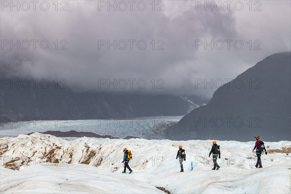 Hikers on the Exploradores glacier in the San Valentin massif