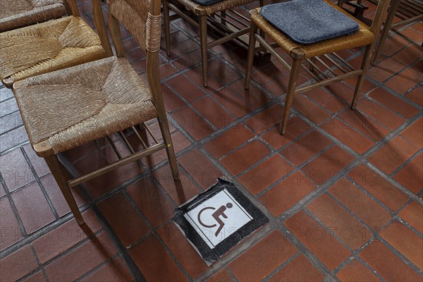 Wheelchair symbol next to a row of chairs